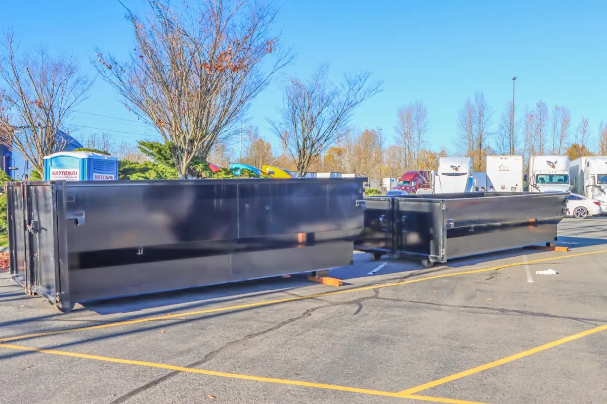 Professional dumpster rental service with roll-off container on residential driveway in Tucker